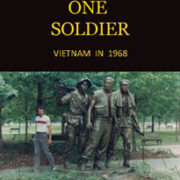 photo of John Shook beside Vietnam Memorial